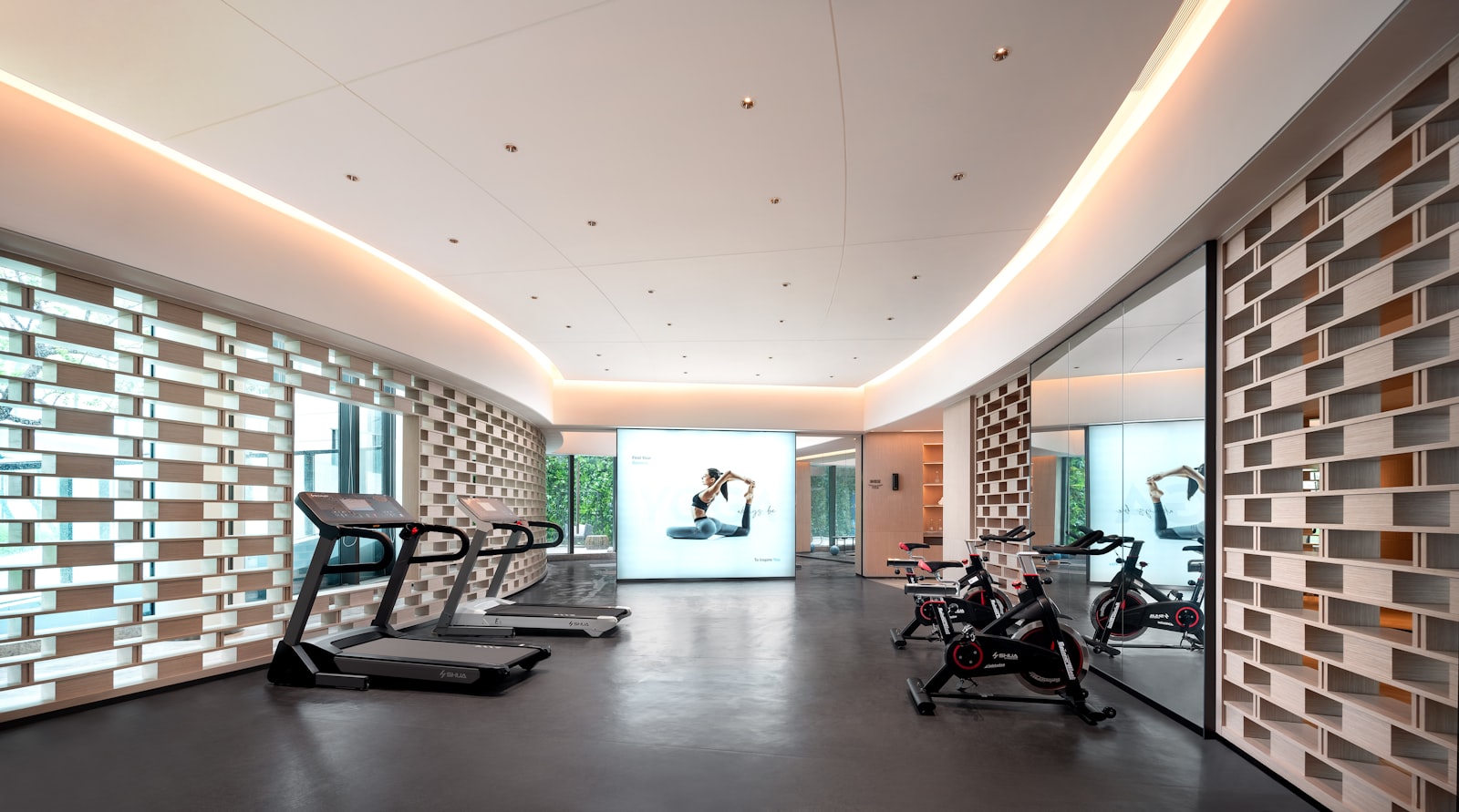 An architectural gym floor with cardio machines