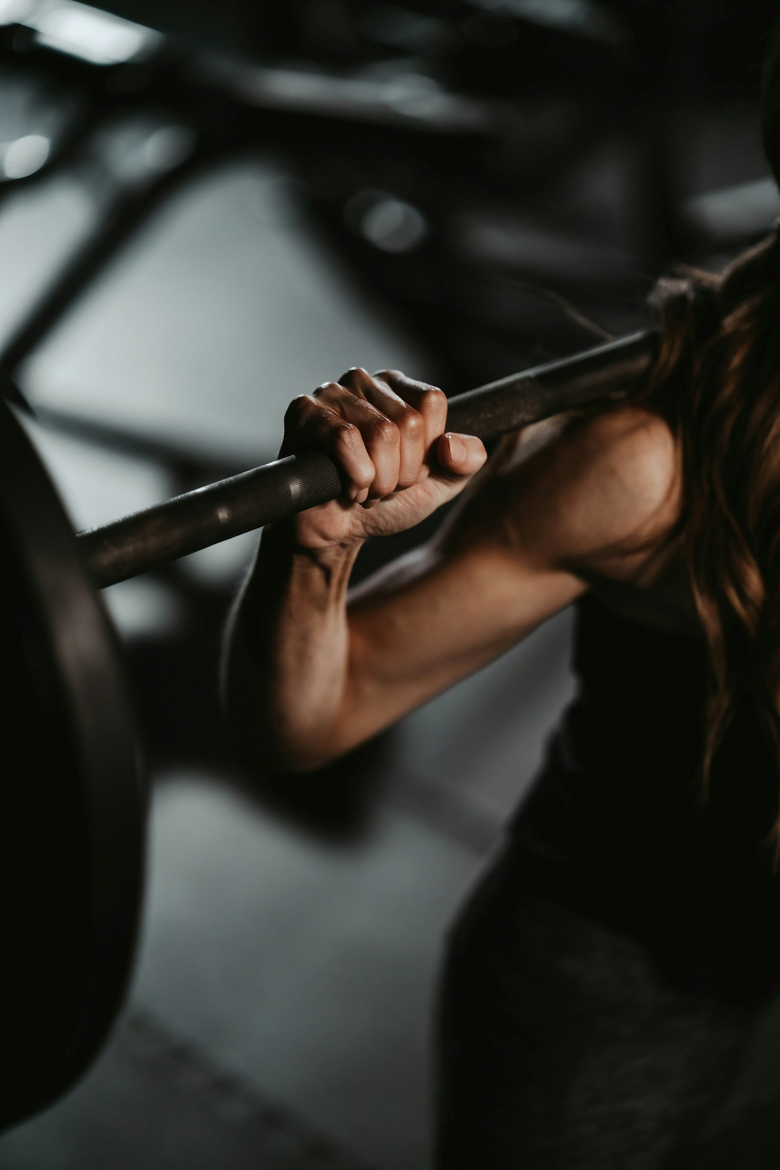 Hands on a barbell, mid-session